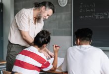 High school math teacher helps two students assess test answers