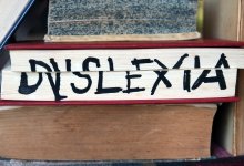 The word "dyslexia" written across the pages of a closed book